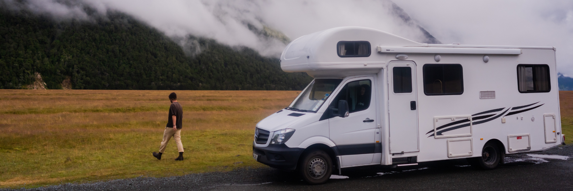 6 berth man walking in field (1920 x 640 px)